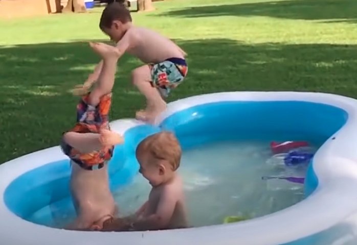 Funny Baby Playing With Water In The Pool